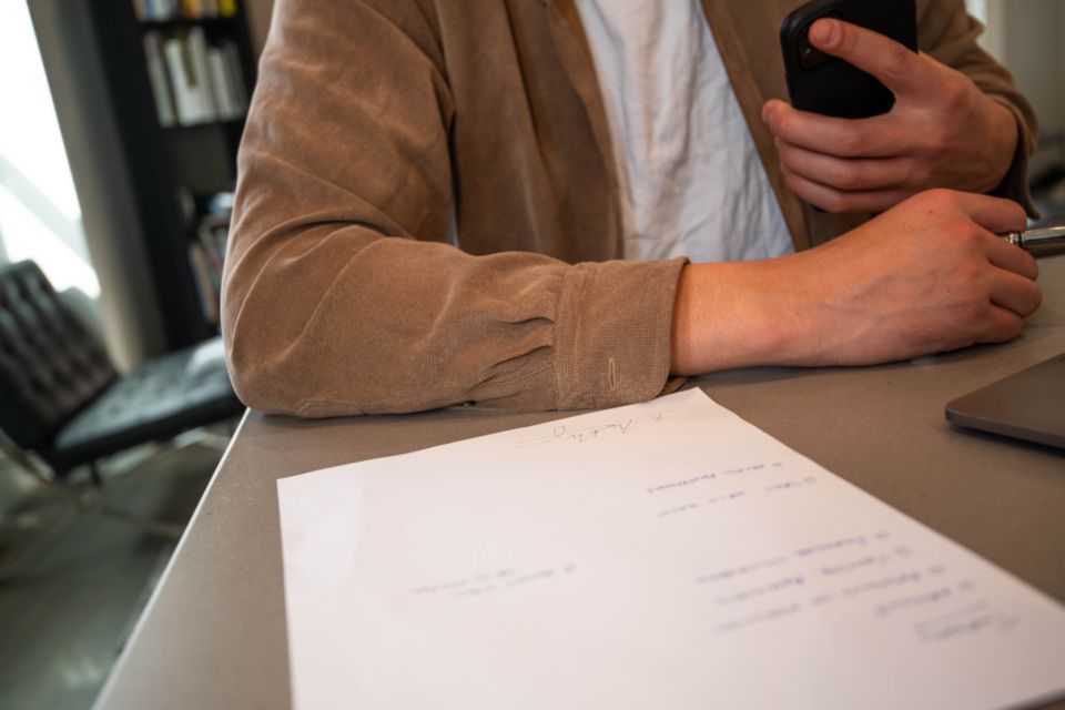 Documents and a pen on a desk during a meeting