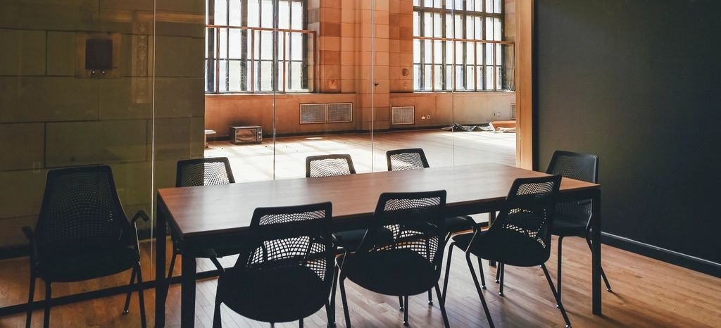 An empty meeting room with a table and chairs